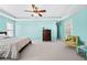 Large, bright primary bedroom with ceiling fan, tray ceiling, and accent wall at 3660 Lake Pass Ln, Suwanee, GA 30024