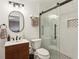 Bathroom with a wood vanity, white walls, modern fixtures and a glass enclosed shower at 3736 Chattahoochee Summit Se Dr # 20, Atlanta, GA 30339