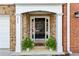 Charming brick home entrance features a black door with white trim and decorative plants at 3736 Chattahoochee Summit Se Dr # 20, Atlanta, GA 30339