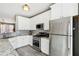 Bright kitchen featuring white cabinetry, stainless steel appliances, and stone countertops at 3736 Chattahoochee Summit Se Dr # 20, Atlanta, GA 30339