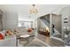 Open-concept living room with stylish furniture, hardwood floors, and a staircase in the background at 3736 Chattahoochee Summit Se Dr # 20, Atlanta, GA 30339