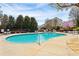 Community pool with tables and chairs surrounding the pool area and trees providing shade at 3736 Chattahoochee Summit Se Dr # 20, Atlanta, GA 30339