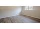 Finished basement area featuring wood-look floors and natural light from the window at 186 Brandi Dr, Hiram, GA 30141