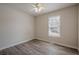 Simple bedroom featuring hardwood floors, a white ceiling fan, and a window at 186 Brandi Dr, Hiram, GA 30141
