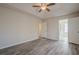 Spacious bedroom featuring wood-look flooring, a ceiling fan, and ample natural light at 186 Brandi Dr, Hiram, GA 30141