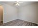 Bedroom featuring hardwood floors, a white ceiling fan and a door to an adjacent room at 186 Brandi Dr, Hiram, GA 30141