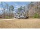 Suburban home with a gray exterior, nestled among trees and a spacious lawn at 186 Brandi Dr, Hiram, GA 30141