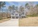 Suburban home with a gray exterior, nestled among trees and a spacious lawn at 186 Brandi Dr, Hiram, GA 30141