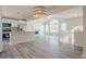 Bright living room with high ceilings, fireplace, kitchen island, and abundant natural light from large arched window at 186 Brandi Dr, Hiram, GA 30141