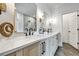 Modern bathroom with dual vanities, sleek fixtures, and a large framed mirror above the counter at 2171 James Aly, Atlanta, GA 30345