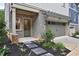 Brick exterior with a covered porch, grey trim, a two-car garage, and a landscaped front yard at 2171 James Aly, Atlanta, GA 30345