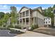 Exterior of a home with covered porches, landscaping, and a sidewalk with brick pillar accents at 2171 James Aly, Atlanta, GA 30345