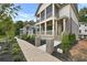 Exterior view of a home featuring a sidewalk, brick pillars, landscaping, and covered porches at 2171 James Aly, Atlanta, GA 30345