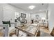Home office with desk, decor, view into living room and adjacent bathroom, and neutral color palette at 2171 James Aly, Atlanta, GA 30345