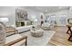 Bright living room with modern decor, neutral tones, stylish seating, and view to stone-accented exterior at 2171 James Aly, Atlanta, GA 30345
