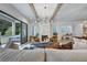 Living room featuring hardwood floors, marble fireplace, modern light fixture, and deck access at 2171 James Aly, Atlanta, GA 30345
