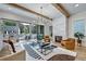 Bright living room boasts hardwood floors, modern light fixture, marble fireplace, and deck access at 2171 James Aly, Atlanta, GA 30345