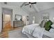 Bright main bedroom featuring tray ceiling, white walls, and a decorative rug on hardwood flooring at 2171 James Aly, Atlanta, GA 30345