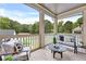 Relaxing screened-in porch with seating, a ceiling fan, and a view of the lush backyard at 2171 James Aly, Atlanta, GA 30345