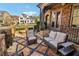 Covered patio space with lounge furniture, a patterned stone floor, and a manicured backyard with an adjacent neighborhood at 4224 Dogwood Bend Park, Duluth, GA 30096