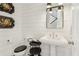 Elegant powder room with pedestal sink, shiplap walls, and decorative accents at 4224 Dogwood Bend Park, Duluth, GA 30096