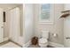 Well-lit bathroom featuring a shower, toilet, and a window, with a neutral color scheme for a clean look at 4224 Dogwood Bend Park, Duluth, GA 30096