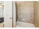 Bathroom featuring a shower-tub combo with tile walls and white shower curtains at 4224 Dogwood Bend Park, Duluth, GA 30096
