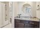 Stylish bathroom with granite counter, dark vanity, round mirror, and shower, combining modern design and functionality at 4224 Dogwood Bend Park, Duluth, GA 30096