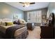 Cozy bedroom with two beds, a ceiling fan, and large window that fills the room with plenty of natural light at 4224 Dogwood Bend Park, Duluth, GA 30096