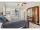 Cozy bedroom featuring a ceiling fan and an antique dark wood wardrobe with mirrored doors at 4224 Dogwood Bend Park, Duluth, GA 30096