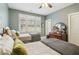 Inviting bedroom with two beds, shuttered windows, ceiling fan, and fresh green walls at 4224 Dogwood Bend Park, Duluth, GA 30096