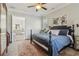 Bedroom with four-poster bed, neutral walls, and view into the ensuite bathroom at 4224 Dogwood Bend Park, Duluth, GA 30096