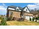 View of house with attached garage, nice lawn, and patio with seating at 4224 Dogwood Bend Park, Duluth, GA 30096