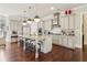 Open kitchen featuring an island with seating, stainless steel appliances, and bright white cabinets at 4224 Dogwood Bend Park, Duluth, GA 30096