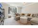 Comfortable living room with a sectional sofa, decorative pillows, and a large window for natural light at 4224 Dogwood Bend Park, Duluth, GA 30096