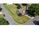 Aerial view of a well-maintained property with a spacious backyard, surrounded by lush greenery and neighborhood streets at 900 Cherringham Ct, Alpharetta, GA 30005