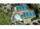 Aerial view of community pool, playground, tennis, and basketball courts, parking and lush greenery at 900 Cherringham Ct, Alpharetta, GA 30005