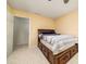 Cozy bedroom with neutral carpeting, and a bed with built-in storage at 900 Cherringham Ct, Alpharetta, GA 30005