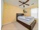 Bedroom features a ceiling fan, carpeted floor, and a patterned accent wall at 900 Cherringham Ct, Alpharetta, GA 30005