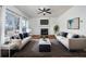 Bright and airy living room with a fireplace, hardwood floors, and modern decor with neutral furniture at 900 Cherringham Ct, Alpharetta, GA 30005