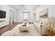 Bright living room featuring hardwood floors, neutral-toned furniture, bay windows, and modern decor at 900 Cherringham Ct, Alpharetta, GA 30005