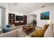 Comfortable living room featuring a large entertainment center, bookshelves, and plush seating at 900 Cherringham Ct, Alpharetta, GA 30005