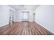 Bright living room featuring hardwood floors, bay windows, and an open layout with white walls at 900 Cherringham Ct, Alpharetta, GA 30005