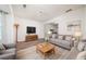 Living room featuring hardwood floors, neutral-toned furniture, modern decor, and ample natural light at 900 Cherringham Ct, Alpharetta, GA 30005