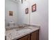 Powder room featuring dark wood cabinets and granite countertop at 900 Cherringham Ct, Alpharetta, GA 30005