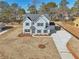 Aerial view of a charming two-story home with blue shutters and landscaped yard at 3725 Heron Creek Ct, Loganville, GA 30052