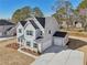 Aerial view of a charming two-story home with blue shutters and landscaped yard at 3725 Heron Creek Ct, Loganville, GA 30052