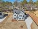 Aerial view of a charming two-story home with blue shutters and landscaped yard at 3725 Heron Creek Ct, Loganville, GA 30052