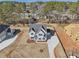 Aerial view of a charming two-story home with blue shutters and landscaped yard at 3725 Heron Creek Ct, Loganville, GA 30052