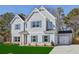 Beautiful two-story home boasts attached garage, blue shutters and green lawn at 3725 Heron Creek Ct, Loganville, GA 30052